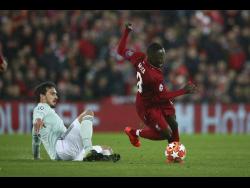 Bayern defender Mats Hummels (left) competes for the ball with Liverpool’s Naby Keita during the Champions League round-of-16 first-leg match at Anfield yesterday. The match ended 0-0. 