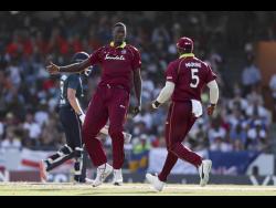 Windies captain Jason Holder celebrates dismissing England’s Jonny Bairstow during their first one-day international cricket match at the Kensington Oval in Bridgetown, Barbados, on Wednesday.
