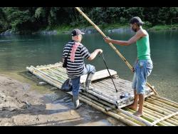 Raft captain Vincent Valentine assists a blind resident, who lives across the Rio Grande in Berrydale, Portland, to get home.