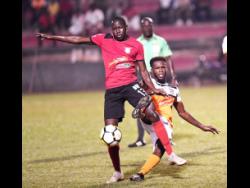 File
Arnett Gardens FC’s Fabian Reid (left) comes under a challenge from Dunbeholden FC’s Clayton Pusey during their Red Stripe Premier League encounter at the Anthony Spaulding Sports Complex on Monday, December 24, 2018.
