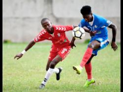 
UWI’s Rochane Smith (left) stays close to Portmore United’s Donnegy Fer in their Red Stripe Premier League encounter at the Spanish Town Prison Oval on Sunday, January 13, 2019. UWI won the game  2-1.