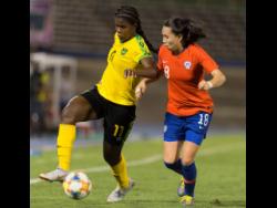 
Jamaica’s striker Khadija Shaw (left) dribbles the ball downfield, while being pressured by Chile’s Camila Sáez during their international friendly held at the National Stadium last night. Jamaica won 1-0. 