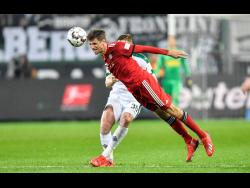 APBayern’s Thomas Mueller jumps for the ball during the German Bundesliga match between Borussia Moenchengladbach and FC Bayern Munich in Moenchengladbach, Germany, on Saturday, March 2. 