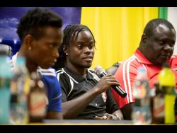
Marvin Morgan (centre) of Arnett Gardens FC responds to a question from a member of the audience at the Red Stripe Premier League press conference held at Jamaica Football Federation in New Kingston on Friday, March 15, 2019. 