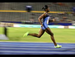 Edwin Allen’s Kevona Davis winning her heat in the Class Two girls 200m on the opening day of the ISSA/GraceKennedy Boys and Girls’  Championships at the National Stadium yesterday. 