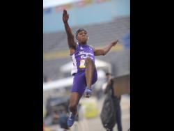 Wayne Pinnock of Kingston College setting a new Boys’ Champs record of 8.05 metres in the  Class One boys long jump at the National Stadium yesterday. 