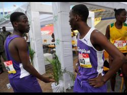 SHORN HECTOR
 Giovouni Henry (left) of Kingston College talks with twin brother Gianni after competing in the Class Two boys 800m semi-finals on day three of the ISSA/GraceKennedy Boys and Girls’ Athletics Championships.