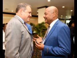 President of CONCACAF Victor Montagliani talks with Michael Ricketts, the president of the Jamaica Football Federation, at a ceremony to announce that Jamaica will be   host venue for this year’s  Gold Cup at The Jamaica Pegasus hotel, yesterday.