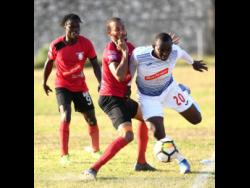 Portmore United’s Rondee Smith (right) goes past Arnett Gardens’ Jamar Martin in a Red Stripe Premier League encounter at the Prison Oval earlier this year.