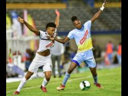 Alex Marshall (left) of Cavalier and Waterhouse’s Ricardo Thomas battle for the ball during the Red Stripe Premier League second-leg semi-final between Cavalier and Waterhouse at the National Stadium on Monday, April 15. Waterhouse won 1-0.