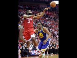 Houston Rockets guard James Harden (13) passes the ball as Golden State Warriors centre Kevon Looney (5) watches during the second half of Game 4 of a second-round NBA basketball play-off series on Monday. 