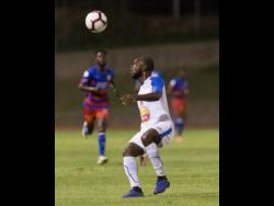 Portmore United’s Javon East prepares to cushion a header during the FLOW Concacaf Club Championship game against Haitian side AS Capoise at Stadium East on Tuesday night. 