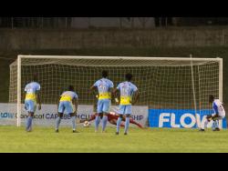 Portmore United’s Javon East (right) scoring a penalty giving his side an early lead against Waterhouse FC in the 2019 FLOW Concacaf Caribbean Club Championship match at Stadium East in Kingston last night. 