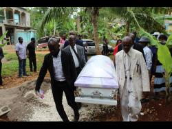 Pall-bearers carry the coffin bearing the remains of Cyslin Brown on Saturday.