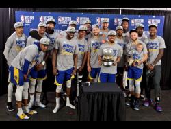 The Golden State Warriors players pose with the Western Conference Championship trophy after Game Four of the NBA basketball play-offs Western Conference finals against the Portland Trail Blazers on Monday.