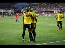 Jamaica forward Shamar Nicholson (11) celebrates his goal with Kevon Lambert (21) during the second half of the team’s international friendly match against the United States on Wednesday.