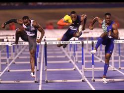 From left: Shane Brathwaite of Barbados finishing second in 13.37 seconds ahead of Hansle Parchment sixth in 13.68 seconds and winner Ronald levy in 13.33 seconds  at the Racers Grand Prix, held at the National Stadium on Saturday.