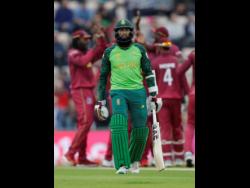 South Africa’s Hashim Amla leaves the pitch after he is caught by West Indies’ Chris Gayle off the bowling of West Indies’ Sheldon Cottrell.