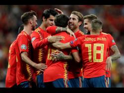 Spain’s Mikel Oyarzabal (centre front) celebrates with teammates after scoring his side’s third goal during the Euro 2020 Group F qualifying match between Spain and Sweden at the Santiago Bernabeu stadium in Madrid yesterday.