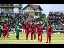 West Indies players walk off dejected after losing the Cricket World Cup match between West Indies and Bangladesh at The Taunton County Ground, Taunton, south west England, yesterday.