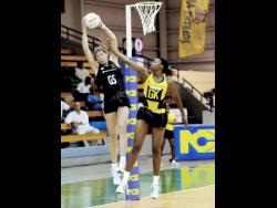 New Zealand’s goal shooter, Irene Van Dyk, catches the ball while she is defended by Jamaica’s goalkeeper, Nicole Aiken at the National Indoor Sports Centre on Thursday, October 22, 2009.