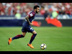 In this file photo dated  Tuesday, May 8, 2018, PSG’s Dani Alves runs with the ball during the French Cup final against Les Herbiers at the Stade de France stadium in Saint-Denis, outside Paris.  