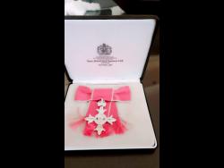 The MBE that was presented to Joan Wilson.  