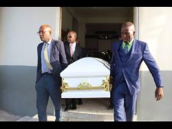 Pall-bearers take the coffin with the body of Gwendolyn Ramsay from the Seventh-day Adventist Church in Falmouth last Sunday. 