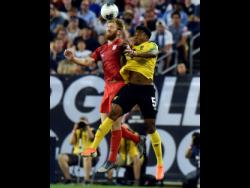 United States defender Tim Ream (left) heads the ball away from Jamaica defender Alvas Powell during the first half of their Concacaf Gold Cup semi-final match at the Nissan Stadium in Nashville, Tennessee last night. 