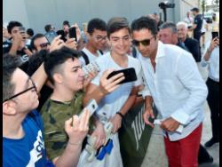 Italian goalkeeper Gianluigi Buffon poses for selfies with fans as he arrives to undergo medical tests at the Juventus Medical Centre in Turin, Italy, yesterday.