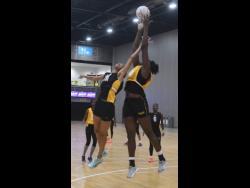 National defender Shamera Sterling (left) attempts a block on teammate Jhaniele Fowler during a training session yesterday, ahead of tomorrow’s game against Fiji at the Netball World Cup in Liverpool, England. Photo courtesy of Collin Reid, Courts Jamaica, Jamaica Tourist Board, Alliance Investments, Dairy Industries and Supreme Ventures.