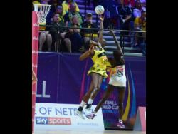 Jhaniele Fowler goes high for a lob pass over South Africa’s goalkeeper, Phumza Maweni, as Jamaica loses their first match of  the 2019 Vitality Netball World Cup. 