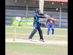 Johnson Mountain captain Gavaskar Malachi plays a shot over point during his innings of 72 not out against Orange in the opening quarter-final match of the SDC/Wray and Nephew National Community T20 cricket competition at Chedwin Park last Saturday.