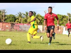 Renoir Elliott (left) of Vere FC battles with Downs FC’s Romario Witter during their JFF All-Island Confederation Play-Offs encounter at the Wembley Centre of Excellence in Hayes, Clarendon, on Sunday, June 3.