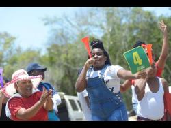 Fans celebrate a boundary in the SDC/ Wray & Nephew T20 Cricket Competition semi-final at the Ultimate Cricket Ground in St Ann yesterday.
