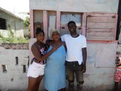 Raquel Gayle(centre), the mother of footballer Shamar Nicholson, stands outside her home in Trench Town, St Andrew, with Nicholson’s siblings, Shamori Nicholson (right) and Kamoya Leckey.