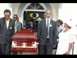 Pall-bearers carry the casket from the church after the thanksgiving service.