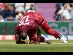 West Indies’ Andre Russell gets up before walking off the field of play with an injury after bowling during the Cricket World Cup match between England and West Indies at the Hampshire Bowl in Southampton, England, on June 14, 2019. 