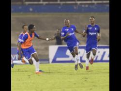 Kingston College’s Trayvone Reid celebrates after scoring a goal in the Manning Cup last year.