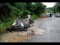 The remains of the Toyota motor car (left) driven by Collin Smith. In background is the truck that crashed into his vehicle.