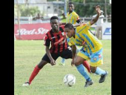 Romario Campbell (right), then of Waterhouse FC, tries to evade Arnett Gardens FC’s Lennox Russell during a Red Stripe Premier League game at the Anthony Spaulding Sports Complex on Sunday, January 22, 2017. File