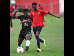 Jermaine Reid (left) of Molynes United makes a challenge on  Lime Hall player Shaquill Wallace  in the JFF Premier league play-off at the  Constant Spring playing field on Sunday, June 2,2019.