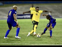 File 
Jamaica striker Darren Mattocks (centre) weaves his way between Tyler Lee (left) and Jermaine Wilson, of the Cayman Islands, during a Concacaf Nations League game at the National Stadium on Sunday, September 9, 2018. 