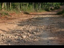 The roads in Gutters Mount, St Catherine, are in a poor state. 