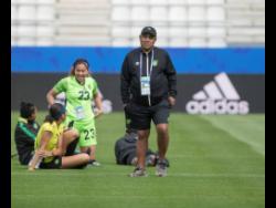 Jamaica senior women's football team head coach Hue Menzies (right) and members of his team during a training session at the FIFA Women's World Cup in France last summer. 