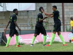 Tyrique Wilson (centre) of Molynes United FC celebrates with teammate Orane Ferguason (right) after firing one past Arnett Gardens FC’s custodian during their RSPL encounter yesterday.