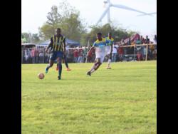 St Elizabeth Technical High School captain Antonio Biggs (right) tracks Munro College’s Torain Young during their ISSA/WATA daCosta Cup game at Munro on September 14, 2019. 