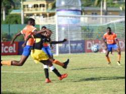 Lennon High’s Gowain Austin (left) tackles the ball from his opponent Clarendon College’s Kodrick Granville (right) during the ISSA/WATA daCosta Cup match at the Montego Bay Sports Complex on September 7.