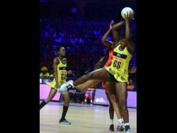 Jamaica goal shooter Jhaniele Fowler (right) acrobatically grabs a pass while her teammate Shanice Beckford looks on during their Vitality Netball World Cup fifth place play-off at the M&S Bank Arena in Liverpool, England on July 21, 2019. 
