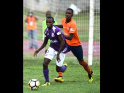 Kingston College’s Arymanya Rodgers (left) dribbles away from Dunoon Technical’s Omari Morgan during their ISSA/Digicel Manning Cup encounter at the Stadium East field on Monday, September 10, 2018.